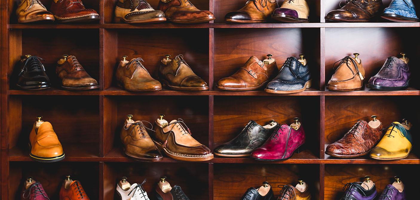 Leather shoes in colours on shelf